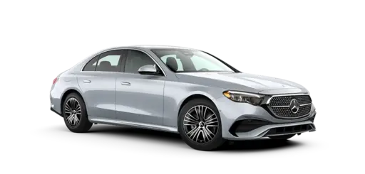 Silver Mercedes-Benz luxury sedan shown in a front three-quarter view, featuring a prominent grille with Mercedes emblem, sleek LED headlights, aerodynamic body lines, alloy wheels, and a refined four-door design on a transparent background.